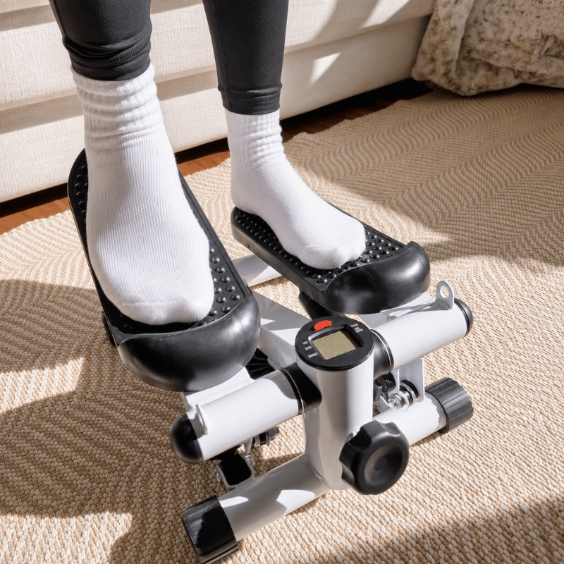 StepTone Mini Stepper White feet on pedals close up